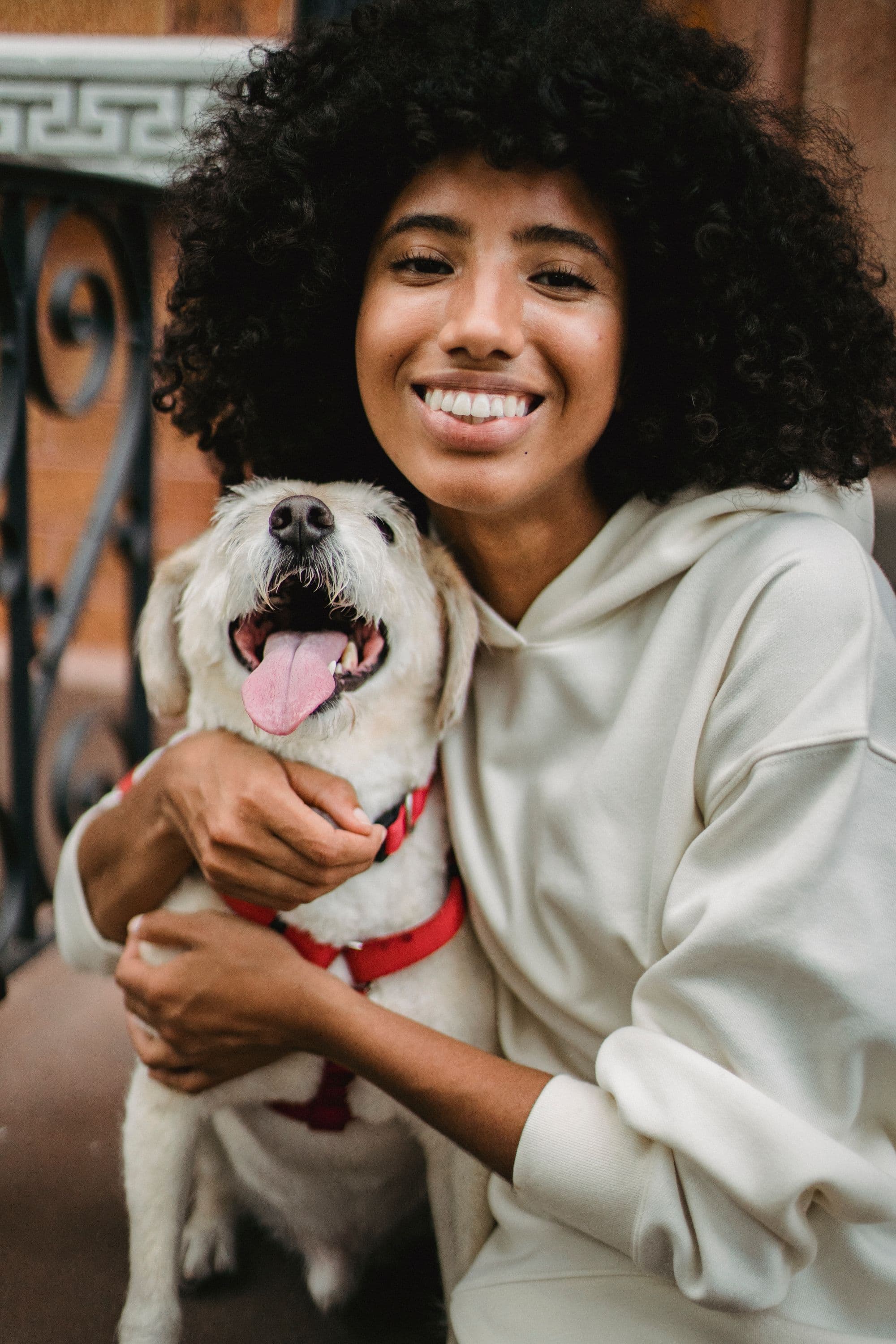 A woman hugging her happy dog