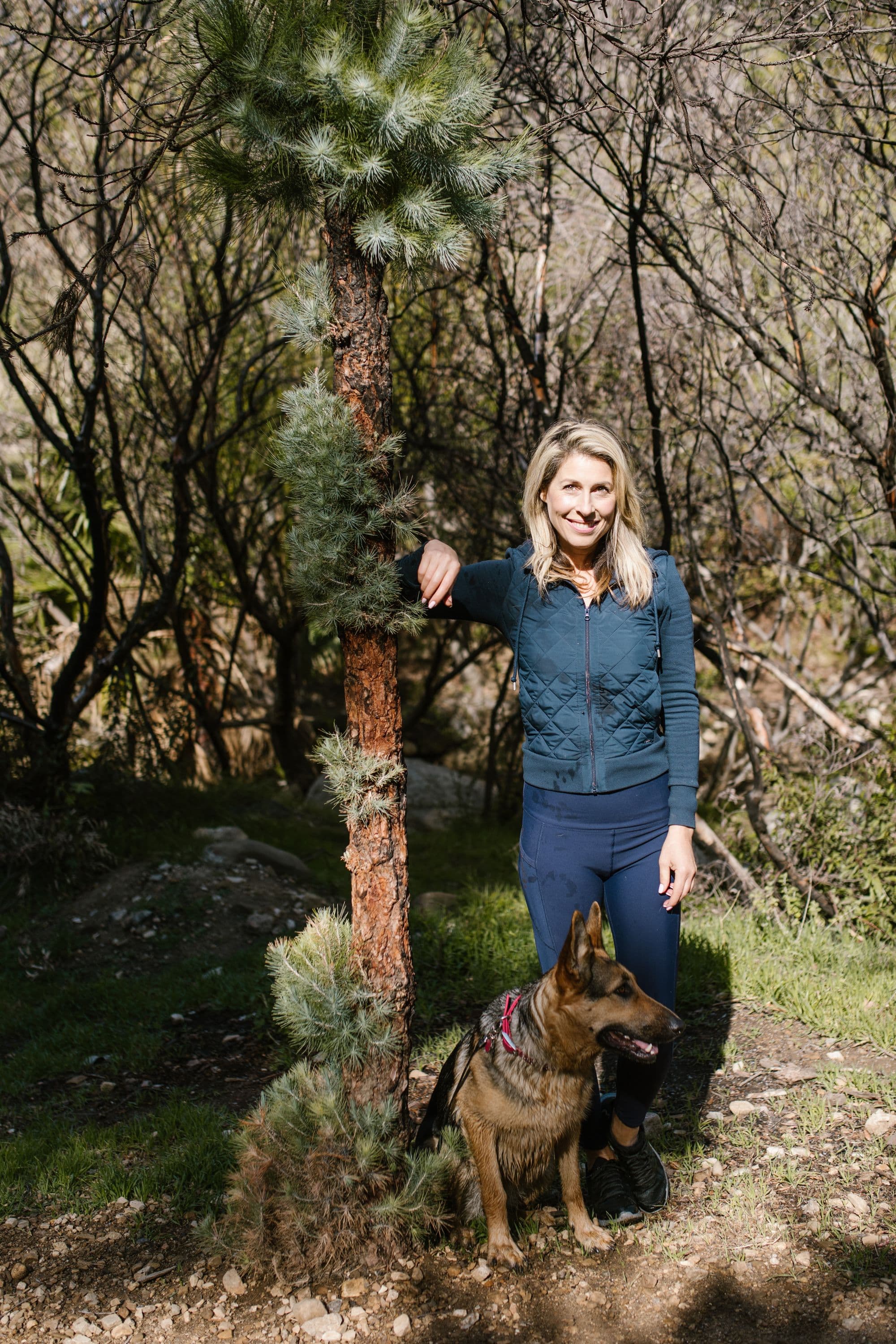 A woman outdoors with her shepherd